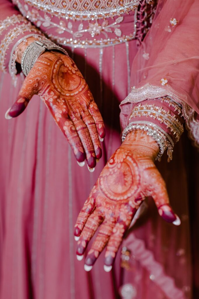 Close-up of the female hands with intricate henna artwork