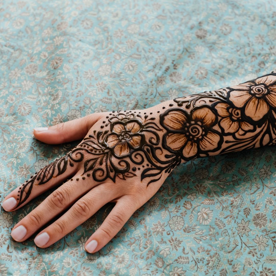 Henna tattoo on woman hands, artist drawing Arabic mehndi